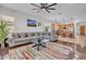 Comfortable living room showing a gray sofa, coffee table, open kitchen, recessed lights, and hardwood floors at 8820 W Glenn Dr, Glendale, AZ 85305