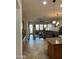 Open living space with kitchen island, dining area, and living room with natural light at 8820 W Glenn Dr, Glendale, AZ 85305