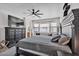 Main bedroom with a large bed, dark wood furniture, TV, and plenty of natural light at 8820 W Glenn Dr, Glendale, AZ 85305