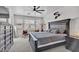 Spacious main bedroom with a large bed, dark furniture, and a ceiling fan at 8820 W Glenn Dr, Glendale, AZ 85305