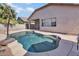 Inviting backyard pool with lush landscaping and a surrounding concrete patio at 8820 W Glenn Dr, Glendale, AZ 85305