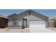 Charming single-story home with neutral stucco, attached two-car garage, and simple desert landscaping at 10314 S 58Th Ln, Laveen, AZ 85339