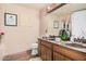 Bathroom with double sink vanity, warm tones, and decoratively framed mirror at 10480 W Martin Rd, Casa Grande, AZ 85194