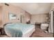 A spacious bedroom featuring wood-look flooring, a comfortable bed, and a cozy sitting area at 10480 W Martin Rd, Casa Grande, AZ 85194