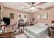 Bedroom with ceiling fan, wood-look floors, and vanity area at 10480 W Martin Rd, Casa Grande, AZ 85194