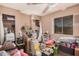 A cluttered bedroom with wood-look floors and a ceiling fan at 10480 W Martin Rd, Casa Grande, AZ 85194