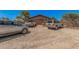 Photo of the graveled driveway with multiple vehicles parked in front of a garage at 10480 W Martin Rd, Casa Grande, AZ 85194