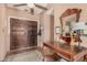 Charming foyer features a wood entry door and decorative mirror with wood table at 10480 W Martin Rd, Casa Grande, AZ 85194