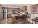 Functional kitchen with island seating, stainless steel refrigerator and tile flooring at 10480 W Martin Rd, Casa Grande, AZ 85194