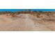 Photo of dirt road leading to the property with sparse desert landscaping at 10480 W Martin Rd, Casa Grande, AZ 85194