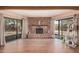 Open living room with a brick fireplace, ceiling beam and sliding door at 10480 W Martin Rd, Casa Grande, AZ 85194