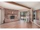 Open living room with a brick fireplace, ceiling beam and sliding door to the exterior at 10480 W Martin Rd, Casa Grande, AZ 85194