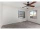 Bright bedroom with a ceiling fan, two windows, and neutral carpet at 11260 N 92Nd St # 2102, Scottsdale, AZ 85260