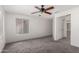 A bright bedroom with a ceiling fan, neutral carpet, and a window at 11260 N 92Nd St # 2102, Scottsdale, AZ 85260