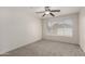 Neutral bedroom with carpeting, ceiling fan, and a bright window at 11260 N 92Nd St # 2102, Scottsdale, AZ 85260