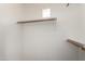 Spacious walk-in closet with built-in shelving and wooden rods for hanging clothes at 11260 N 92Nd St # 2102, Scottsdale, AZ 85260