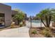 Gated community pool area surrounded by lush landscaping and the condo buildings, offering a refreshing and secure recreational space at 11260 N 92Nd St # 2102, Scottsdale, AZ 85260