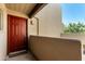 Welcoming entryway with a vibrant red front door, decorative details, and unit number at 11260 N 92Nd St # 2102, Scottsdale, AZ 85260