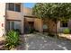 Condo exterior features a walkway, stairs to units above and lush vegetation and beautiful trees at 11260 N 92Nd St # 2102, Scottsdale, AZ 85260