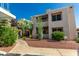 Inviting condo exterior with a walkway, well-maintained landscaping, and stylish architectural details at 11260 N 92Nd St # 2102, Scottsdale, AZ 85260