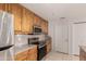 Updated kitchen features stainless steel appliances, granite counters, and wood cabinets at 11260 N 92Nd St # 2102, Scottsdale, AZ 85260