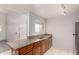 Kitchen with granite countertops, wood cabinets, stainless steel appliances, and tiled floors at 11260 N 92Nd St # 2102, Scottsdale, AZ 85260