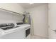 Laundry room has newer washer and dryer, water heater, and shelving at 11260 N 92Nd St # 2102, Scottsdale, AZ 85260