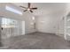 Bright living room boasts sliding glass doors to outdoor space, carpet, and vaulted ceilings at 11260 N 92Nd St # 2102, Scottsdale, AZ 85260