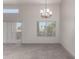 Open-concept living space with carpet, a modern chandelier, sliding doors to a patio, and natural light at 11260 N 92Nd St # 2102, Scottsdale, AZ 85260