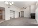 Spacious living room features open layout, carpet, ceiling fan, fireplace, and built-in shelving at 11260 N 92Nd St # 2102, Scottsdale, AZ 85260