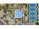 Overhead view of community pool, tennis courts, lush landscaping and a nearby parking lot at 11439 E Bella Vista St, Scottsdale, AZ 85259