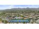 Scenic aerial view of community pool and tennis courts with mountain views in the distance at 11439 E Bella Vista St, Scottsdale, AZ 85259