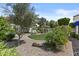 Backyard featuring desert landscaping, a playhouse, a seating area, and mature trees at 11439 E Bella Vista St, Scottsdale, AZ 85259