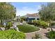 Landscaped backyard featuring a grassy area, mature trees, a pool, and a patio with retractable awnings at 11439 E Bella Vista St, Scottsdale, AZ 85259