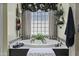 Luxurious bathroom with a soaking tub and a glass block window at 11439 E Bella Vista St, Scottsdale, AZ 85259