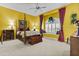 Bright bedroom featuring a canopy bed, window seat, and neutral carpet at 11439 E Bella Vista St, Scottsdale, AZ 85259