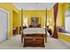 Bright bedroom featuring a canopy bed, window seat, and neutral carpet at 11439 E Bella Vista St, Scottsdale, AZ 85259