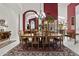 A sophisticated dining room with a large wooden table and elegant chandelier at 11439 E Bella Vista St, Scottsdale, AZ 85259