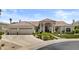 Stunning single-story home with a tile roof, lush landscaping, and a three-car garage on a sunny day at 11439 E Bella Vista St, Scottsdale, AZ 85259
