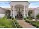 Elegant home featuring a grand entrance with columns, tile roof, arched windows, and lush landscaping at 11439 E Bella Vista St, Scottsdale, AZ 85259