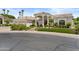 Stately home with well-manicured lawn, portico entry, arched doorway, tile roof, and three-car garage at 11439 E Bella Vista St, Scottsdale, AZ 85259