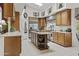 Spacious kitchen with light countertops, stainless steel appliances, a center island, and tasteful decorative accents at 11439 E Bella Vista St, Scottsdale, AZ 85259