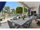 Covered patio with outdoor dining furniture, pool view, and blue sky at 11439 E Bella Vista St, Scottsdale, AZ 85259