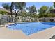Sparkling swimming pool surrounded by lush landscaping and blue skies at 11439 E Bella Vista St, Scottsdale, AZ 85259
