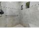 Tiled shower with a built-in niche and pebble floor at 11439 E Bella Vista St, Scottsdale, AZ 85259