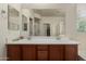 Bathroom features double sinks with wood cabinets, a large mirror, and a walk-in shower at 11959 W Pierce St, Avondale, AZ 85323