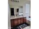 This bathroom has a dual sink vanity, soaking tub, glass shower, and natural light at 11959 W Pierce St, Avondale, AZ 85323