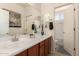 Bright bathroom with a long vanity, decorative vases, and a shower/tub combo at 11959 W Pierce St, Avondale, AZ 85323