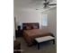 Cozy bedroom features a comfortable bed and ample natural lighting from the window at 11959 W Pierce St, Avondale, AZ 85323