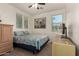 This bright bedroom offers natural light from multiple windows, soft carpet, and ample storage at 11959 W Pierce St, Avondale, AZ 85323